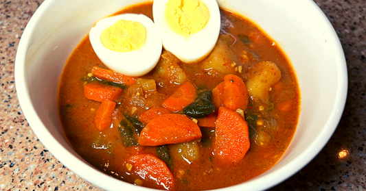 veggie curry soup - a spicy soup served in a white bown with hard boiled eggs